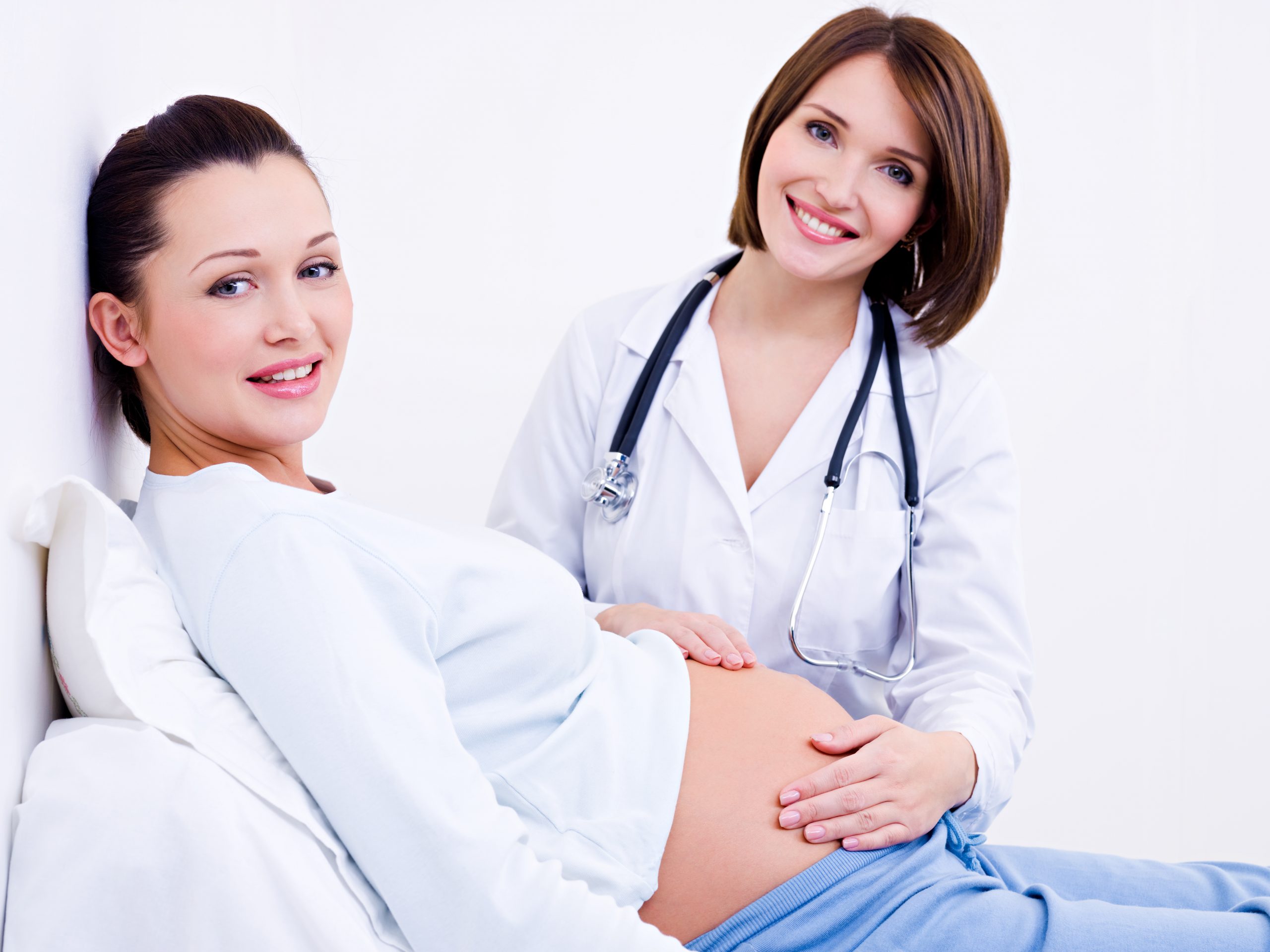 Doctor feels pregnant woman's stomach